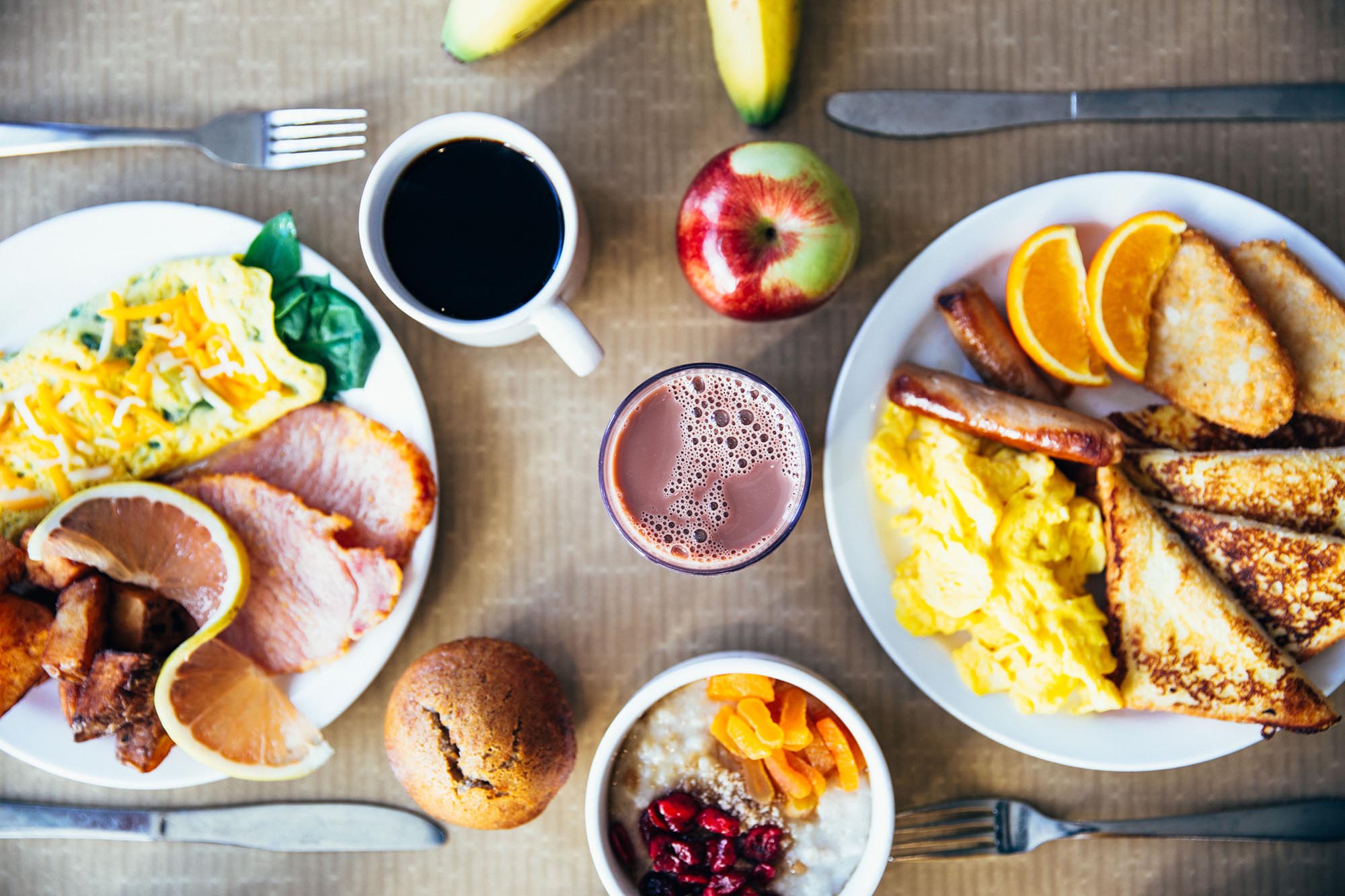 A breakfast spread of pancakes, toast, fruit, and a smoothie, everyday foods whose carb content often surprises people counting carbs